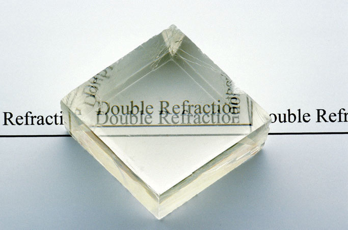 The phrase 'Double Refraction' can be seen through an Iceland crystal, except it appears doubled, with the two images slightly overlapping